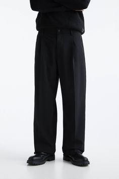 Wide-leg smart trousers featuring front darts, belt loops and button and zip fly fastening.