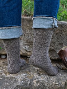 This top-down, richly-textured sock in two sizes S(L) is a gorgeous accessory for men and women alike. Worked in a warm, wooly yarn it is a hiking/rowing/snowshoeing essential; in sleek, smooth yarn it is a stylish accent to casual suits or slacks. With cabled details on all sides and cushy moss stitch panels, it is fun to work and a small project to be proud of—plus, a gift that says you think the most of a special someone. Shown here is size S in Border Leicester Fingering, color Rainbow GrayS Casual Winter Hiking Socks, Casual Hiking Socks For Winter, Casual Knit Winter Socks, Hand Knitted Fitted Casual Socks, Casual Fitted Hand Knitted Socks, Casual Hand Knitted Fitted Socks, Casual Hand-knitted Fitted Socks, Casual Fitted Socks For Outdoor, Handmade Casual Socks For Fall