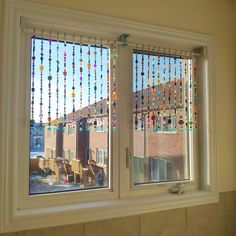 two windows with glass beads hanging from them