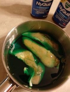 a pan filled with green liquid sitting on top of a counter