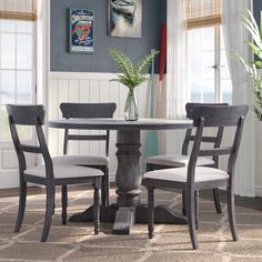 a dining room table with four chairs around it