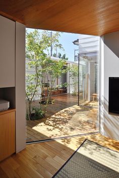 an open living room with wood flooring and sliding glass doors leading to the backyard