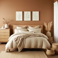 a bedroom with a bed, dresser and two pictures hanging on the wall above it