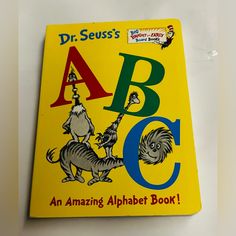 a yellow book with an image of dr seuss's abc