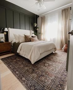 a bed sitting on top of a rug in a bedroom