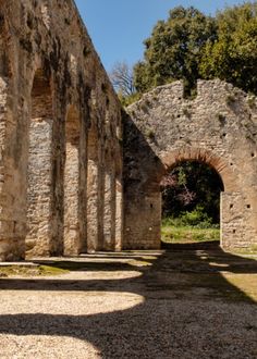 an old building with stone walls and arches