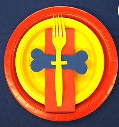 a red and yellow plate with a fork on it