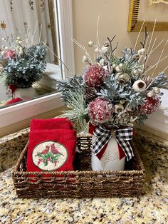 a basket filled with christmas decorations on top of a bathroom counter next to a mirror