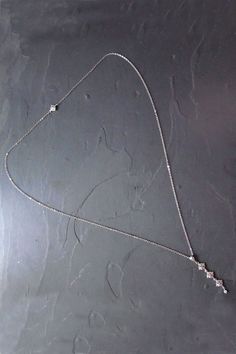 Give your low back dress a touch of bling with this art deco inspired back necklace with a delicate crystal backdrop that this perfect for your dress. #artdeco #backnecklace #backdropnecklace Silver Lariat Necklace With Diamond Accents For Wedding, Wedding Lariat Necklace With Diamond Accents In Cubic Zirconia, Silver Backdrop Necklace, Diamond Lariat Backdrop Necklace For Wedding, Elegant Silver Backdrop Necklace With Adjustable Chain, Adjustable Silver Backdrop Necklace, Sterling Silver Wedding Backdrop Necklace With Adjustable Chain, Dainty Silver Adjustable Backdrop Necklace, Silver Diamond Lariat Backdrop Necklace