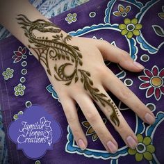 a woman's hand with henna tattoos on it