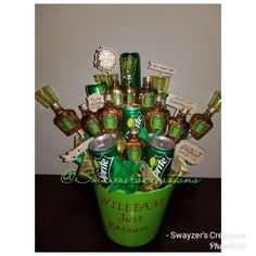 a green bucket filled with lots of different types of liquor