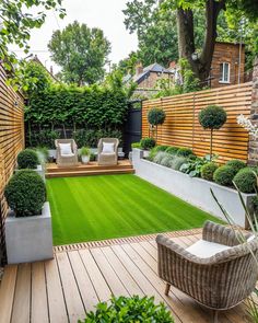 an outdoor garden with grass and wooden decking