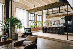 a living room filled with furniture and lots of windows