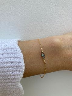 This dainty crystal bracelet is perfect for the minimalist. Labradorite is a magical stone that has an ethereal flash that can be golden, blue, green pink or purple. D E T A I L S  *It features a trio of  beautiful blue flash labradorite gemstones. *These have been wire wrapped to a dainty chain. Choose between 14k gold-filled, rose gold-filled or sterling silver. *It closes with a hall marked gold filled/sterling silver spring ring clasp. *Bracelet comes with care instructions and a matching cr Minimalist Adjustable Labradorite Jewelry, Dainty Labradorite Jewelry For Everyday, Elegant Birthstone Jewelry With Labradorite, Blue Labradorite Bracelet, Dainty Adjustable Gemstone Chain Bracelet, Minimalist 14k Gold Filled Bracelets With Birthstone, Dainty 14k Gold Filled Birthstone Bracelets, Blue Minimalist 14k Gold Filled Bracelets, Tiny Sterling Silver Minimalist Bracelet