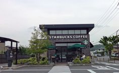 the starbucks coffee shop is located on the corner of the street in front of an intersection