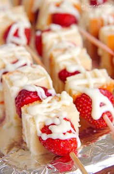 strawberry shortcakes with white icing and strawberries on top are ready to be eaten