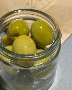 Green olives in a transparent glass jar Olives Photography, Olives Aesthetic, Felix Escellun, Spanish Olives, 2024 Color, Eat To Live, People Eating, Bar Cabinet