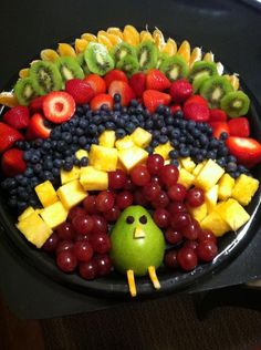 a fruit platter with a smiley face on it