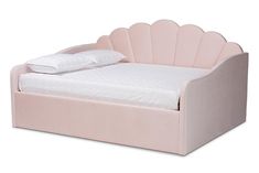 a pink bed with a white pillow on it's headboard and foot board