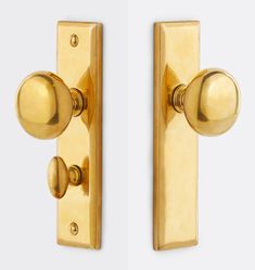 two golden door handles with knobs on each side and one has a round handle