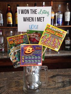 a glass mug filled with candy sitting on top of a counter next to a sign that says i won the party when i met you