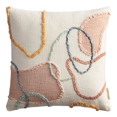 an embroidered pillow with various colored beads on the front and back, along with a tasseled edge