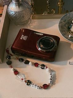 a camera and some beads on a table