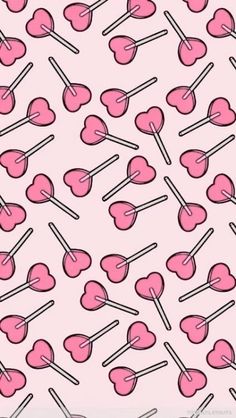 pink candy lollipops are arranged on sticks in the shape of heart shapes