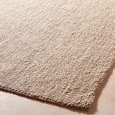 a white rug on top of a floor with no one in the room looking at it