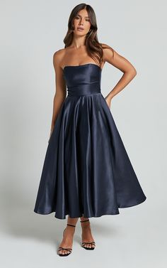 Elevate your formal wear game with the Helaina Midi Dress. This stunning strapless A-line satin dress in navy is the epitome of elegance and sophistication. Made from high-quality polyester, it features a flattering ball gown silhouette that will make you feel like a queen at any event.The strapless design adds a touch of allure to the dress, allowing you to show off your shoulders and collarbone effortlessly. The midi length falls just below the knee, striking the perfect balance between trendy and timeless.Whether you're attending a wedding, prom, or any other special occasion, this dress is sure to turn heads wherever you go. Its deep navy color exudes confidence and refinement, while the luxurious satin fabric adds a touch of luxury to your ensemble.Not only does this Helaina Midi Dres Blue Wedding Guest Outfit, Moot Court, Showpo Dress, Year 12 Formal, Midi Prom Dress, Ball Gown Silhouette, Emmys Red Carpet, Midi Wedding Dress, Midi Bridesmaid Dress