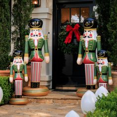 two large nutcrackers are standing in front of a door