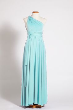 a woman's dress on a mannequin with one shoulder draped over it