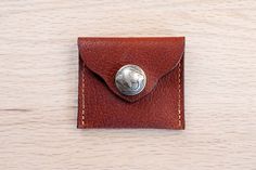 This small square leather coin purse comes in black or brown full grain leather. It features an authentic genuine Buffalo nickel. This handy coin case will help you keep change organized in your pocket, purse, or car. We handcraft this coin purse from American Bison full grain leather so it's tough and durable. These cases make great gifts too! It's Made in USA and built to last! Leather Coin Purse As Gift, Leather Coin Purse For Gift, Leather Bifold Coin Purse For Daily Use, Leather Coin Purse With Smooth Grain As Gift, Bifold Coin Purse With Snap Closure As Gift, Leather Coin Purse With Snap Closure As Gift, Leather Coin Purse With Snap Closure For Gift, Wallet With Coin Pocket For Everyday Carry, Handmade Brown Bifold Coin Purse