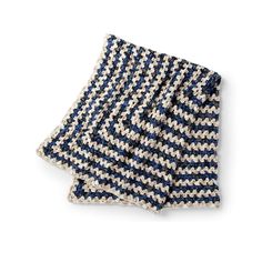 a blue and white knitted dishcloth on a white background, folded in half