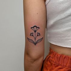 a woman's arm with a flower tattoo on the left side of her body