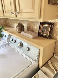 a white washer sitting next to a dryer in a kitchen