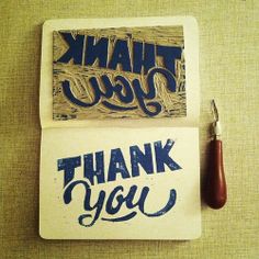 two thank you cards and a pen on a table