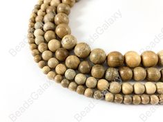 three strands of wood beads on a white background