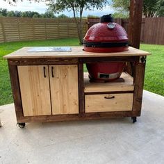 a big red bbq grill sitting on top of a patio