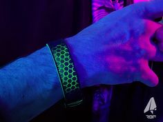 High-tech rubber! This piece is comprised of a black iridescent band over top florescent green hex pattern that shifts color and brightness based on the viewing angle. This wristband appears primarily black until it is seen under ultraviolet light which reveals its hallucination within.  This wristband is known as PSYubtle-T and comes in fluorescent/black with an adjustable length of 6-23.3cm. Made of fused deposition rubber and plastic forming a durable single piece clasp/band. Our wristbands are made to be the piece of art you want on every trip. RBF products are specially designed to accentuate the effects of certain compounds you may be enjoying. They are infinitely adjustable for the correct fit and lined with soft textured material to boost comfort and breathability. The fluorescent Black Rave Bracelets As Gift, Black Luminous Bracelets For Gift, Neon Glow Party, Black Iridescent, Rave Accessories, Ultraviolet Light, Uv Reactive, Glow Party, Neon Glow