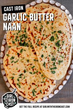 garlic butter naan on a plate with the title cast iron garlic butter naan