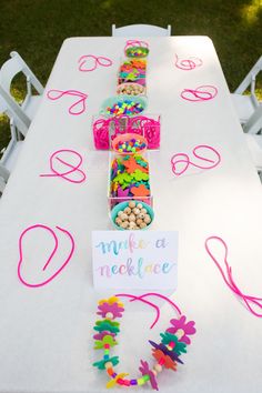 the table is set up with candy and confetti for a birthday party or baby shower