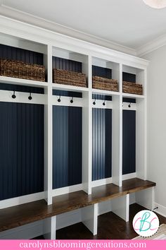 an empty room with some benches and baskets on the wall