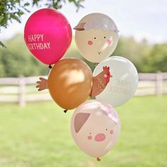 a bunch of balloons that have animals on them and happy birthday written on the balloons