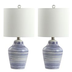 two blue and white striped vases with lamps on each side, one is turned off