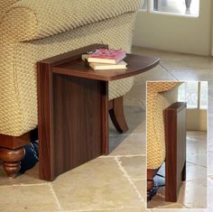 a coffee table with a cell phone on it in front of a chair and window