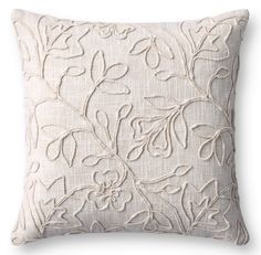 a white pillow with an embroidered design on it