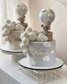 two cakes decorated with balloons and teddy bears