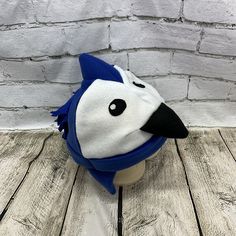 "Adult and Kids Blue Jay Bird Fleece Hat This is a blue bird hat made from white and royal blue fleece. It features stuffed black fleece beak, felt eyes, and fleece feathers on back. Hat Sizes: Baby: Approx. 20\" around Child: Approx. 22\" around Youth: Approx. 23 1/2\" around Adult S/M: Approx. 24\" around Adult M/L: Approx. 25\" around Adult L/XL: Approx. 26\" around Hat shown is a child size on a 18 1/2\" (47cm) head. Care: Machine wash on cool or warm; dry on low. Turnaround time varies thro Bird Hat, Felt Eyes, Blue Jay Bird, Jay Bird, Fleece Hat, Winter Bird, White Fleece, Trapper Hats, Funny Birds