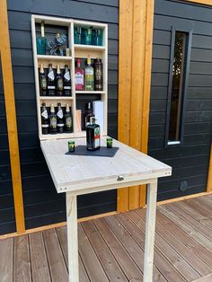 a wooden table with bottles on it outside